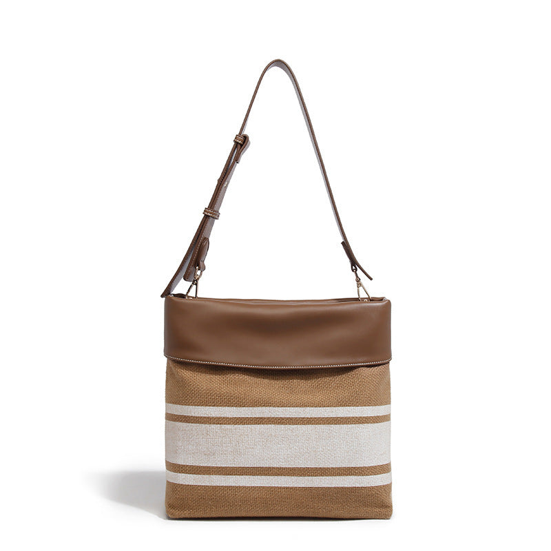 Sac à main en toile robuste avec garniture en cuir pour femmes modernes.