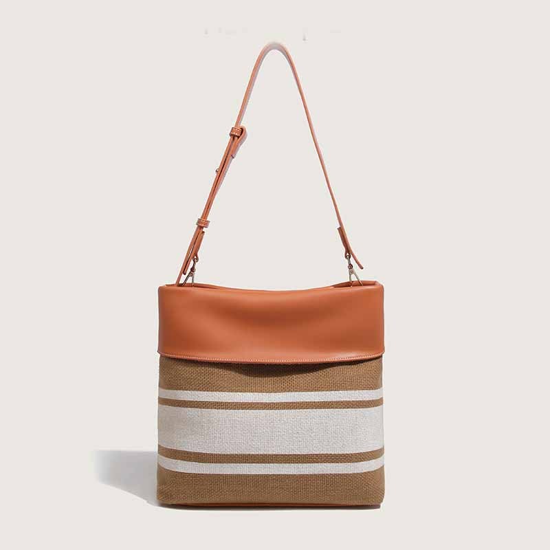 Sac à main en toile robuste avec garniture en cuir pour femmes modernes.