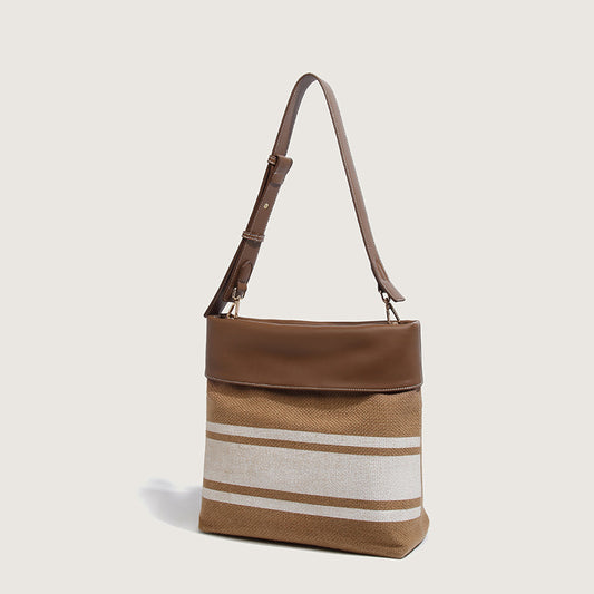 Sac à main en toile robuste avec garniture en cuir pour femmes modernes.